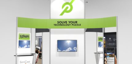new 20 x 20 island trade show island booth design with private meeting area and workstations, modern design