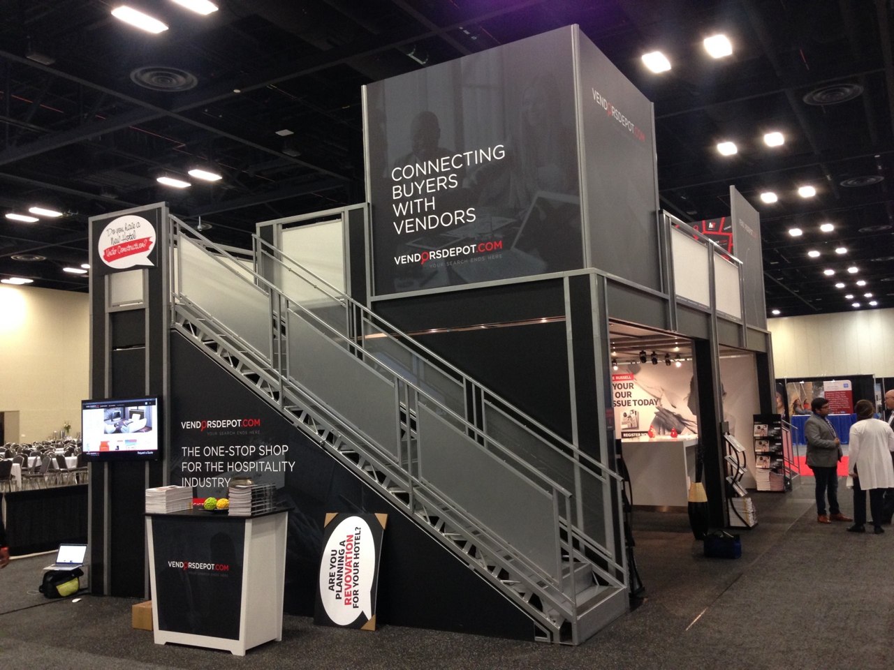 Good graphic messaging on two story trade show exhibit rental