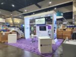 20' Island Trade Show Exhibit With Open Floor Plan And Backlit Graphics